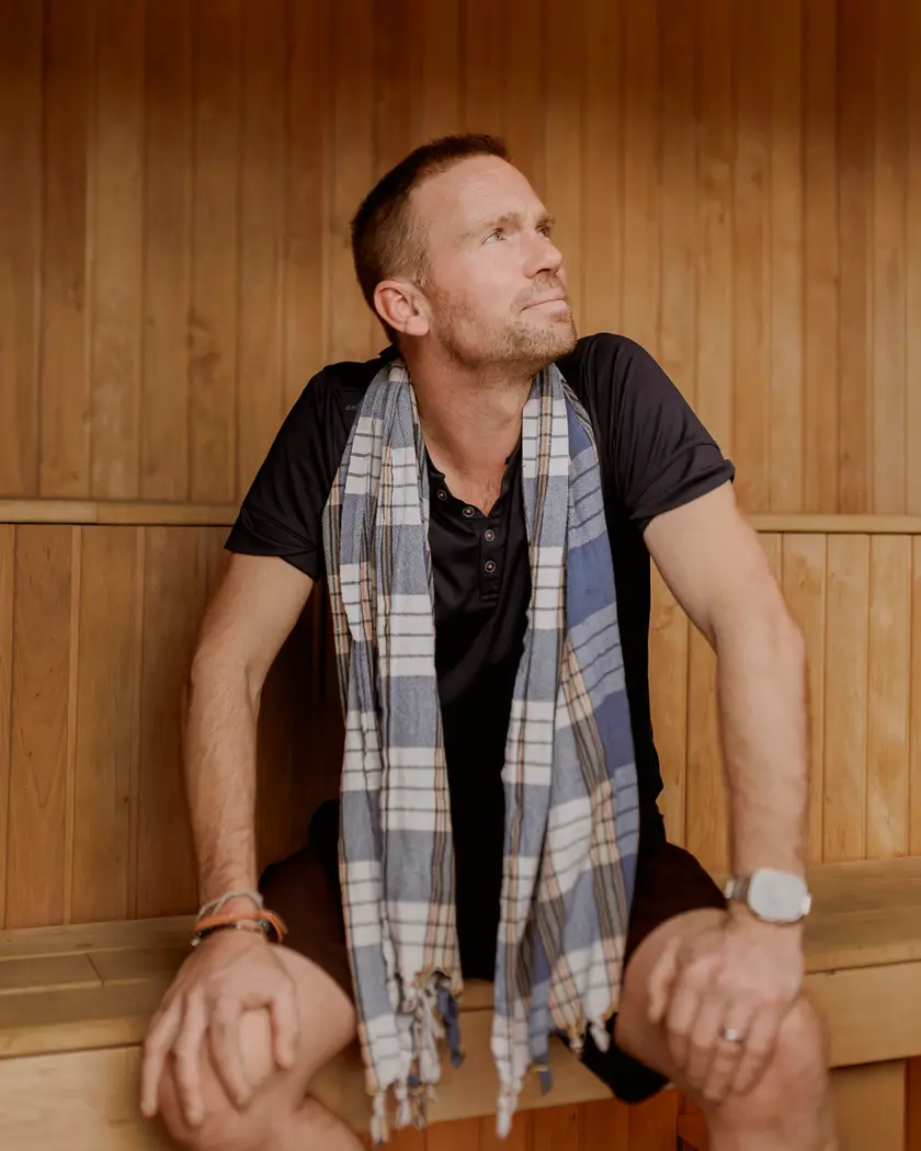 Portrait of Johnny Palmer in a sauna setting.